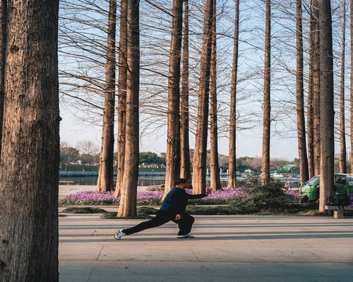 Person doing light stretching in a park